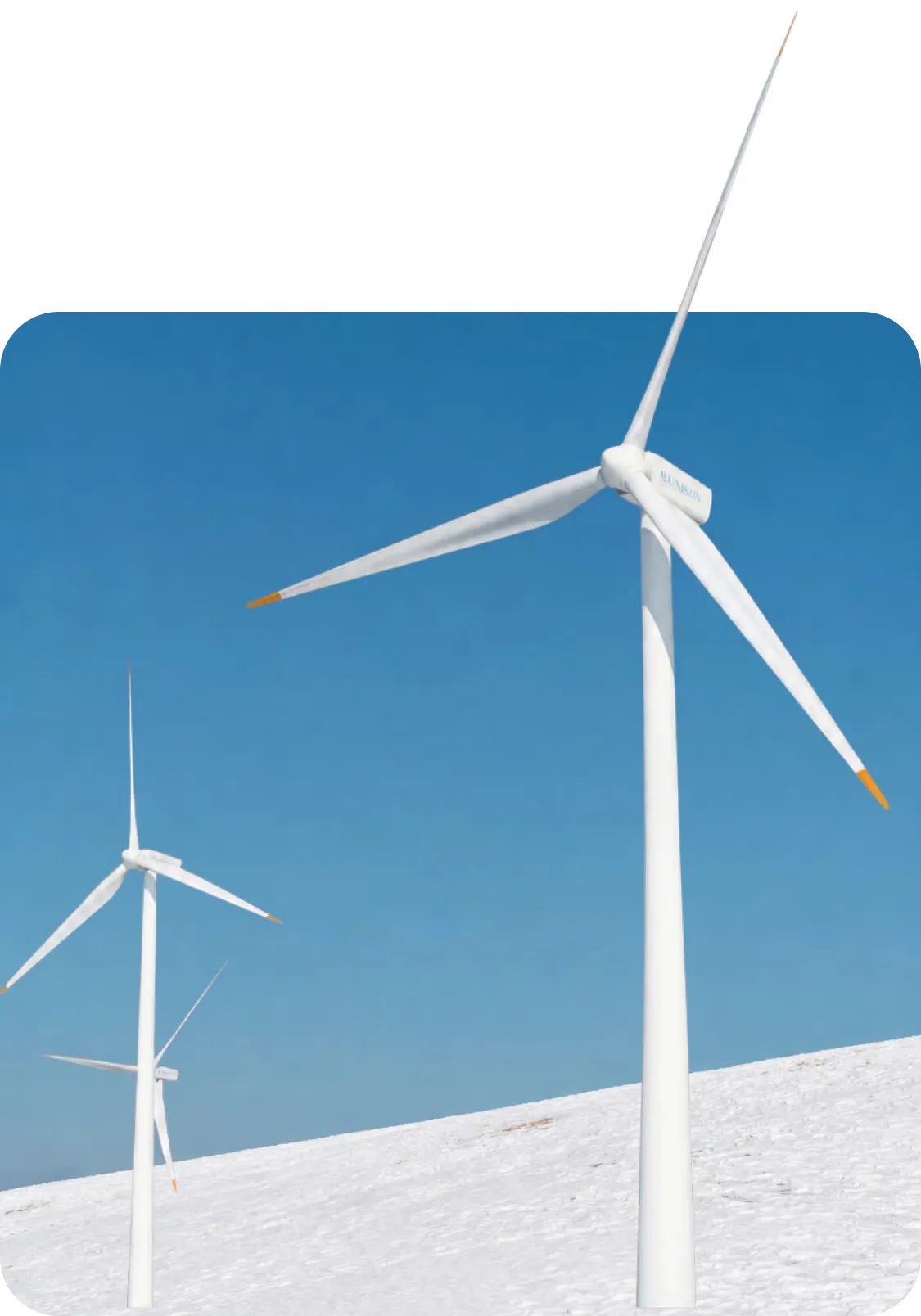 Onshore wind turbines on a ridge with a camera mast in the foreground